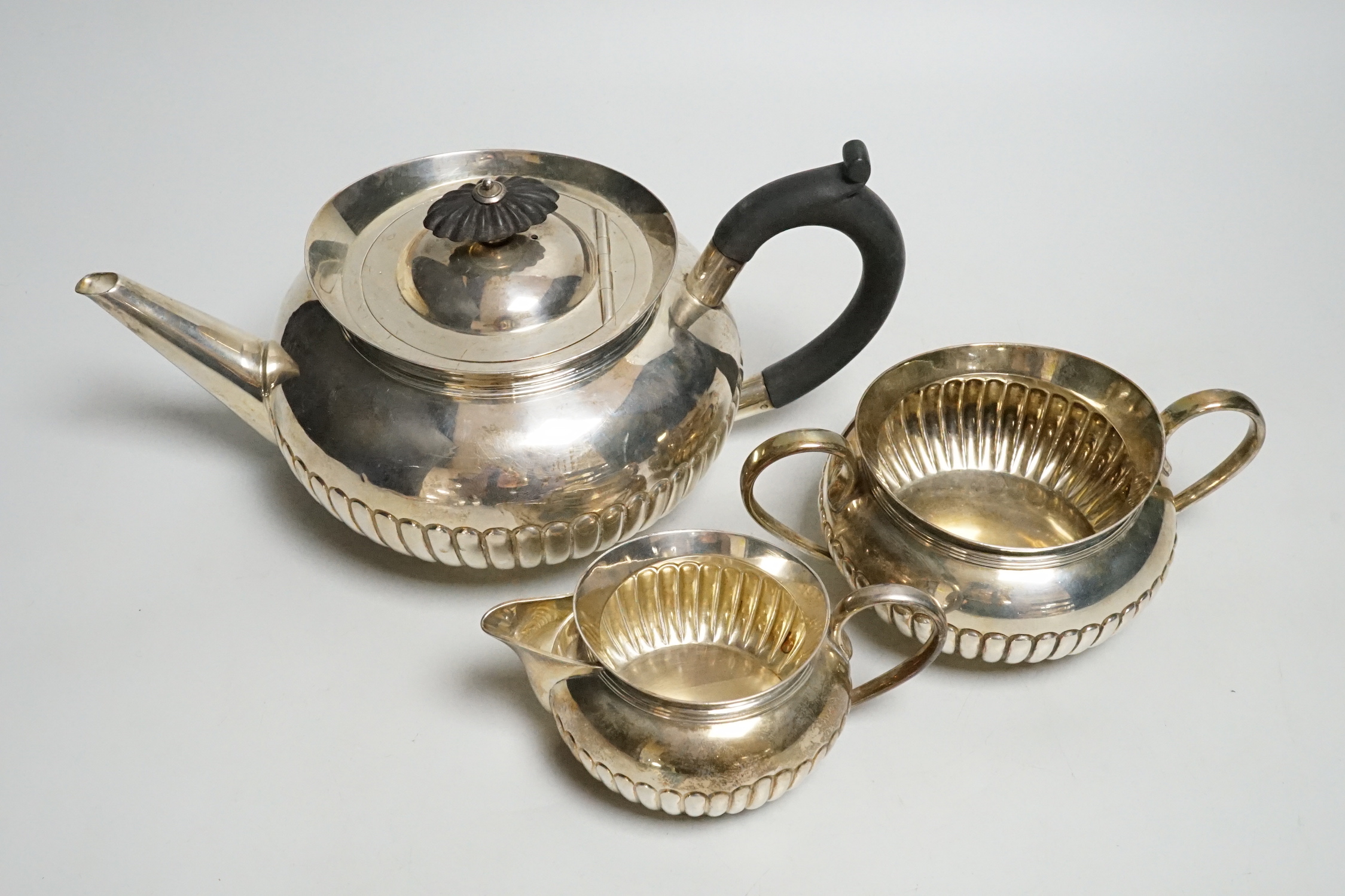 A late Victorian demi-fluted silver three piece tea set, by Hukin & Heath, 1893/4/5, gross weight 27.6oz.